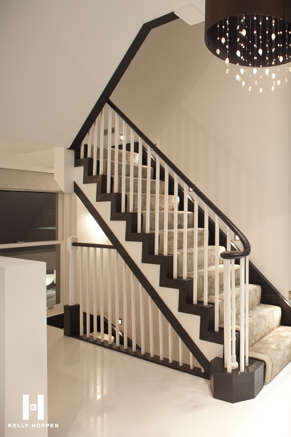 Luxury white and brown staircase with plush beige carpet