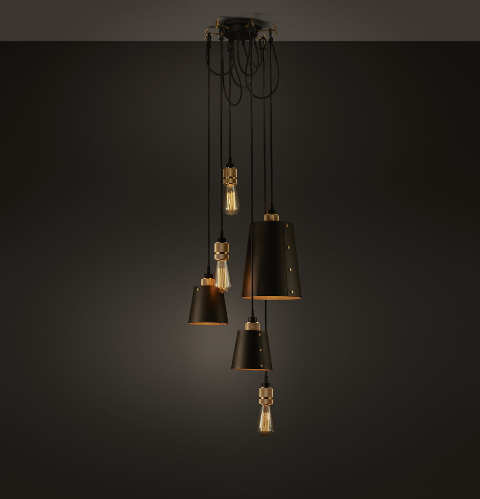 Hanging black and gold chandelier by buster + punch