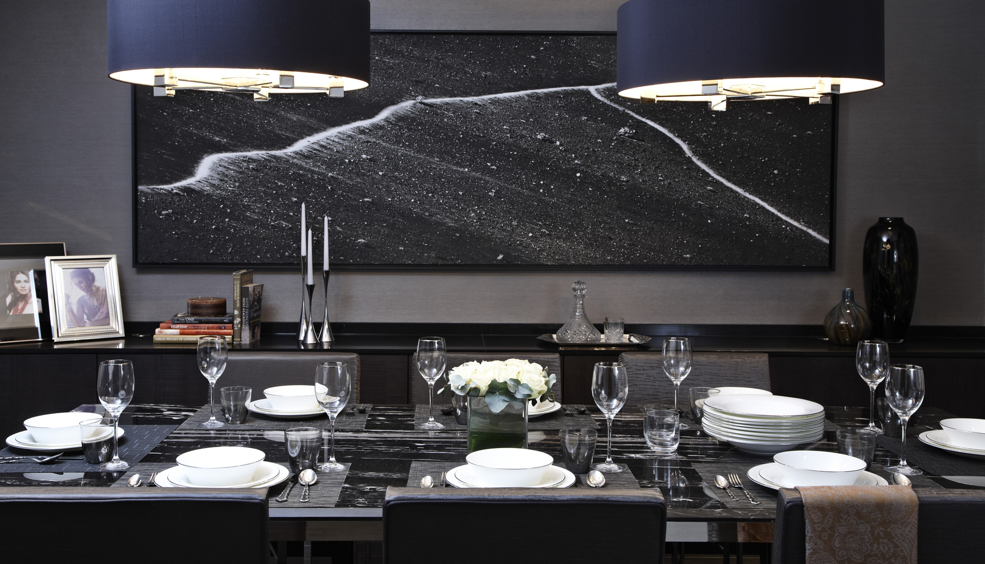 Luxury black and grey dining room with black art